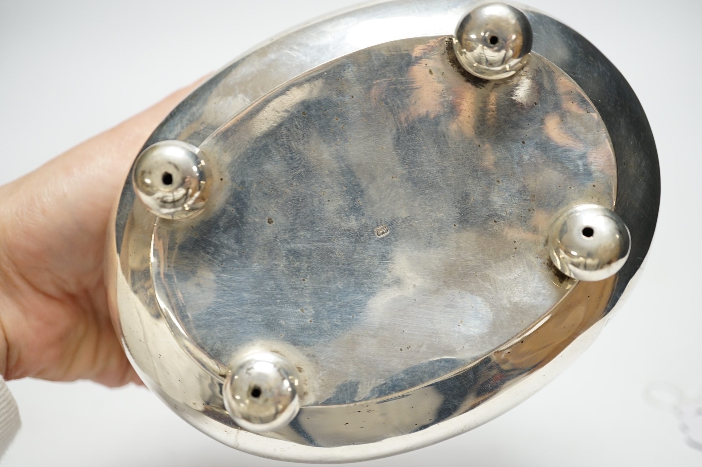 A 19th century German? white metal oval tea caddy, on bun feet, lacking key, width 16cm, 8.8oz.